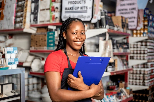 Shop owner restocking shelves using business loan